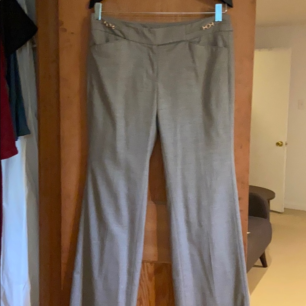 Beige slacks with gold buckle detail